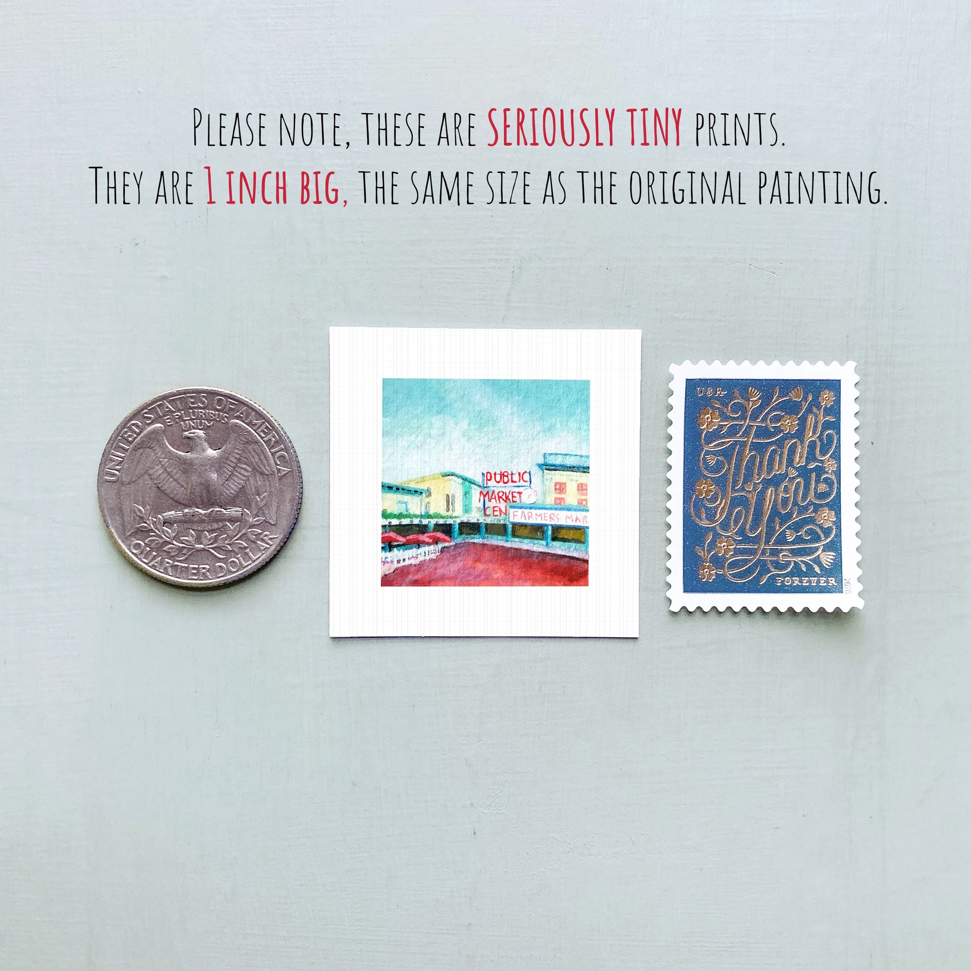 three small prints: a silver coin, a white square print of a building, and a blue postage stamp.