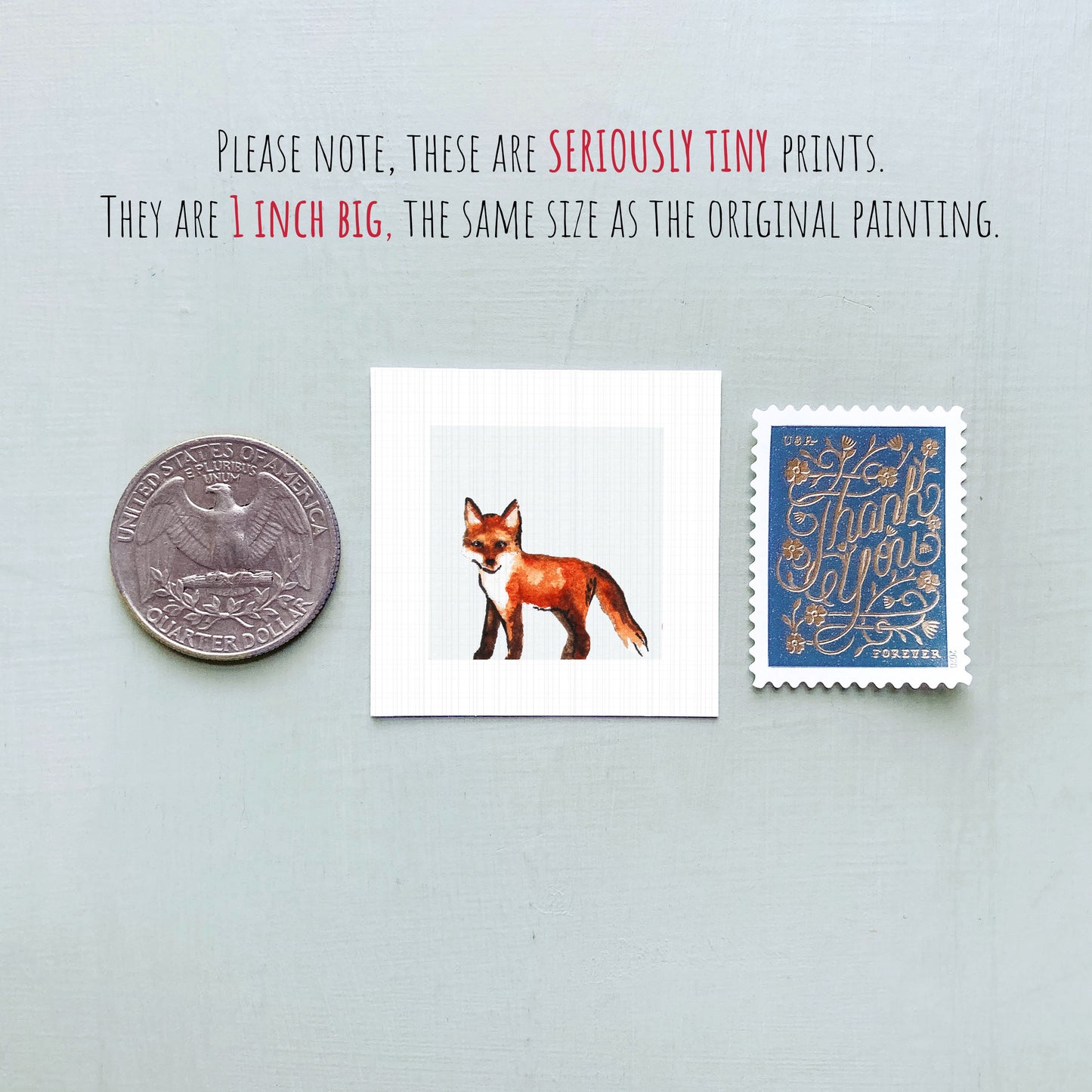 a collection of three small items: a quarter, a stamp, and a painting of a fox.