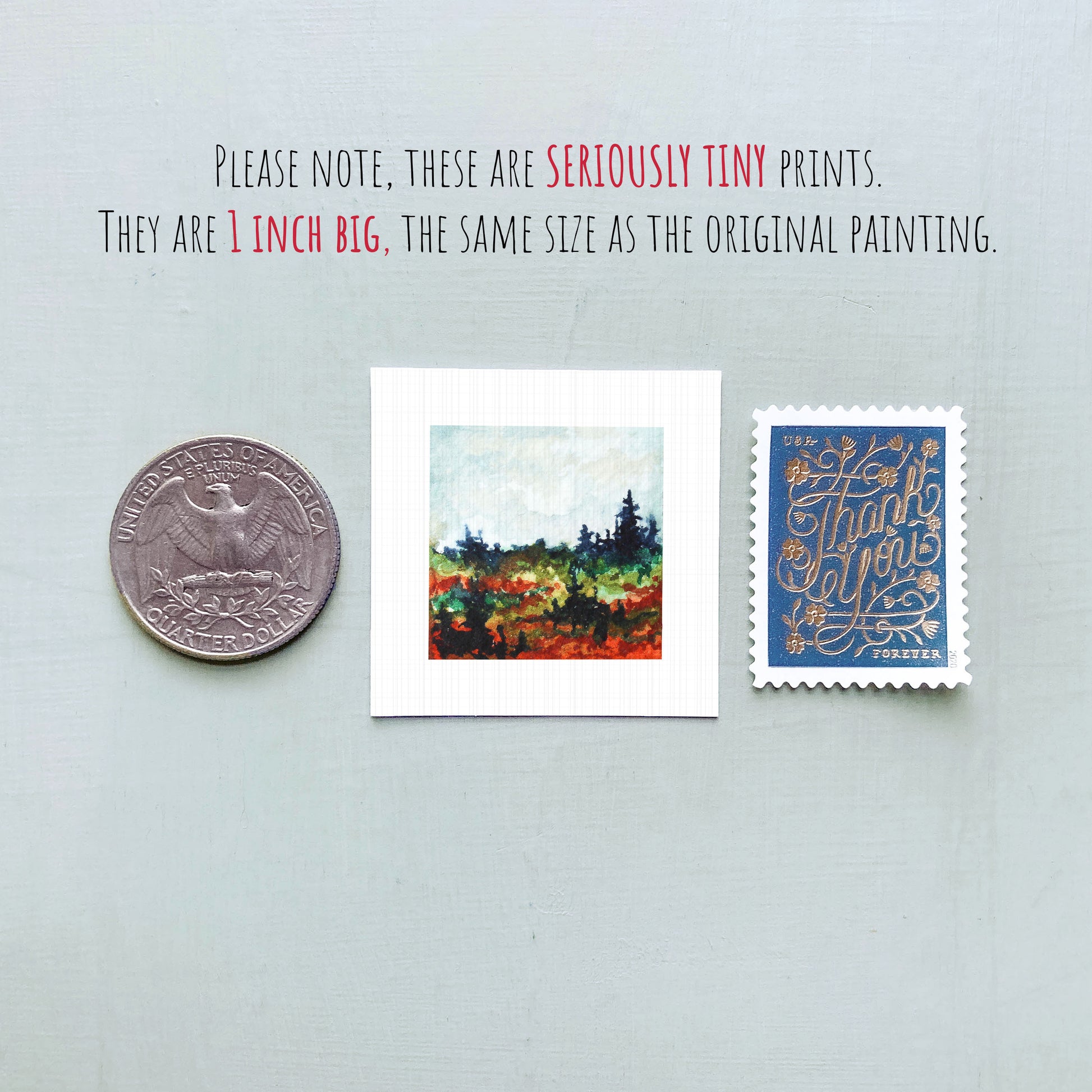 three small prints: a United States quarter, a small painting of a landscape, and a postage stamp.
