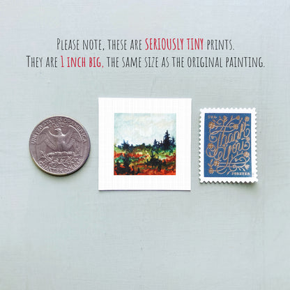 three small prints: a United States quarter, a small painting of a landscape, and a postage stamp.