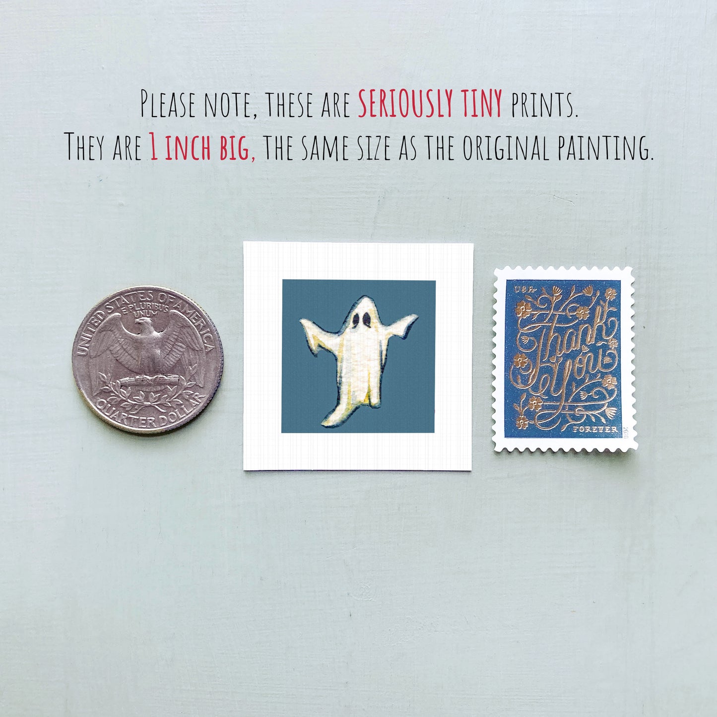 three small items: a quarter, a ghost, and a postage stamp.