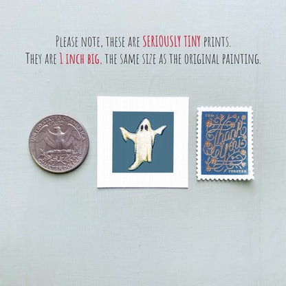 three small items: a quarter, a ghost, and a postage stamp.