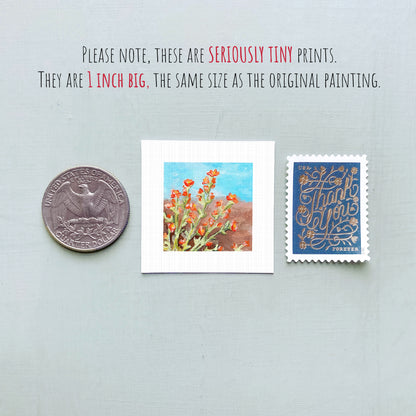three small prints: a silver coin, a white square print of a painting of flowers, and a blue postage stamp with gold lettering.