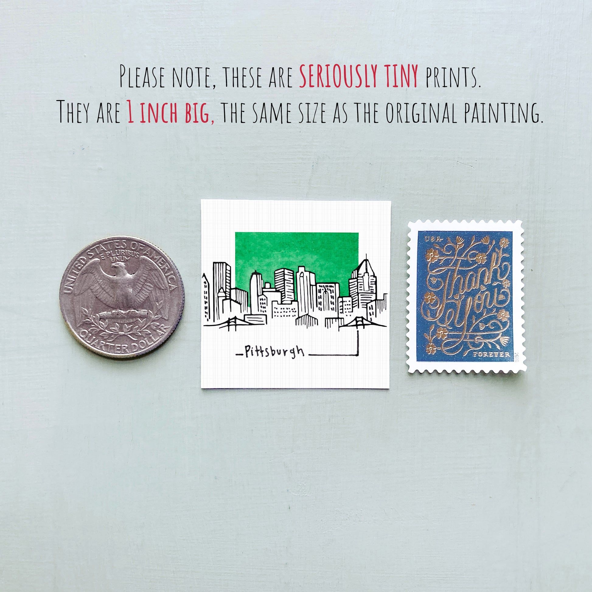 a collection of three small items: a quarter, a miniature drawing of a city, and a postage stamp.