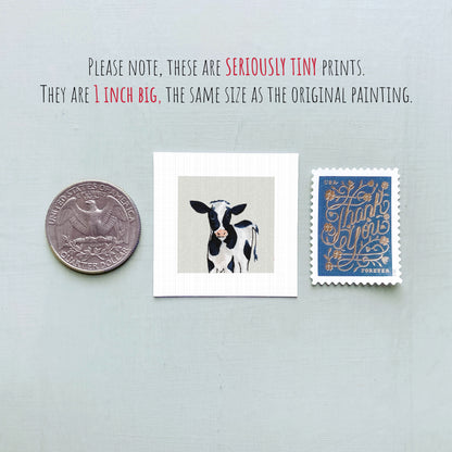 a collection of three small items: a quarter, a square print of a cow, and a postage stamp.