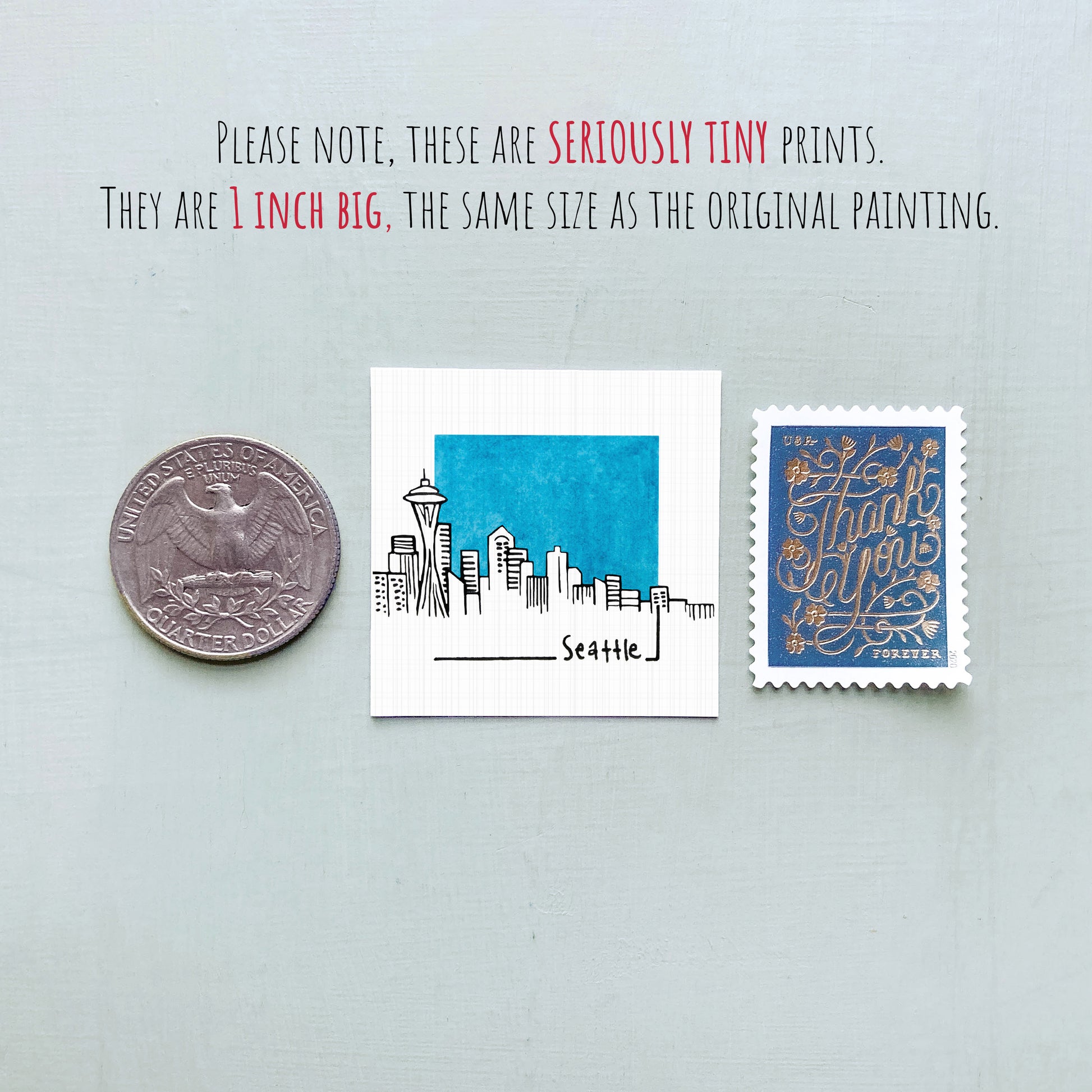three small items: a silver coin, a white square with a blue city skyline, and a blue postage stamp.