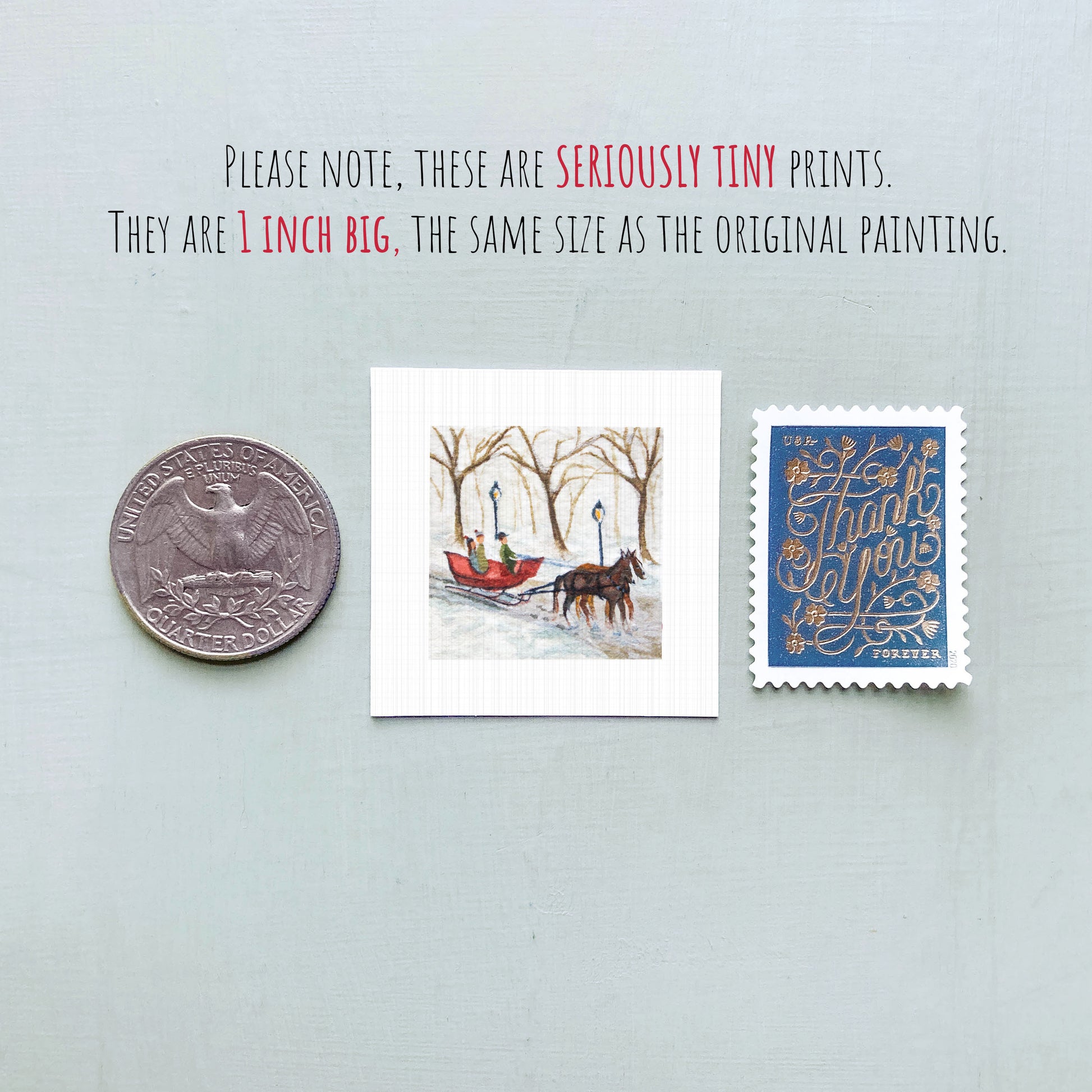 three small art prints and a United States quarter coin, all of which are described as "seriously tiny prints" and "1 inch big," respectively.