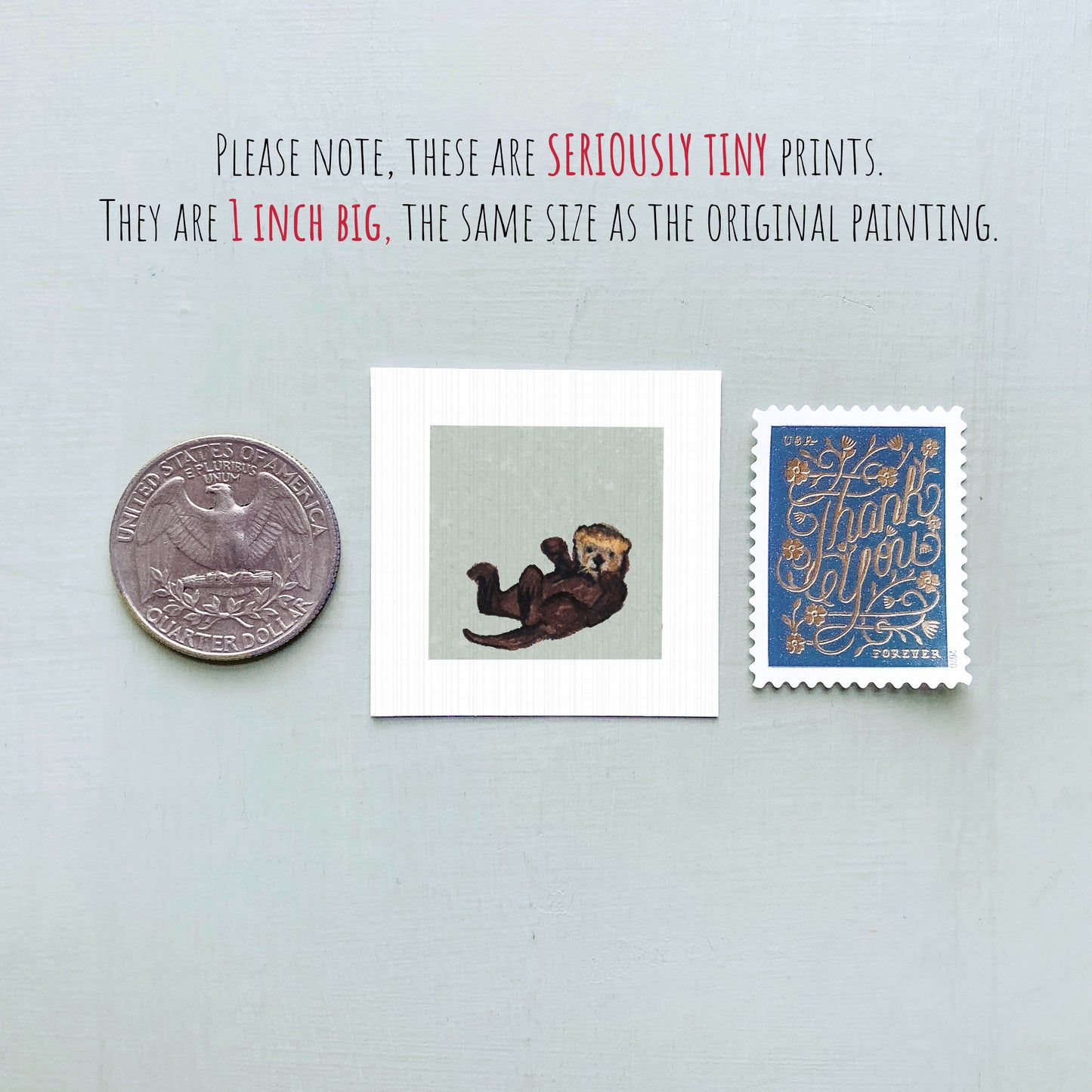 three small items: a quarter, a postage stamp, and a painting of an otter.