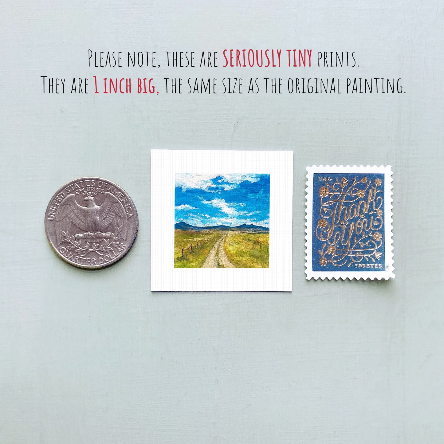 three small prints: a quarter, a postage stamp, and a painting of a rural landscape.