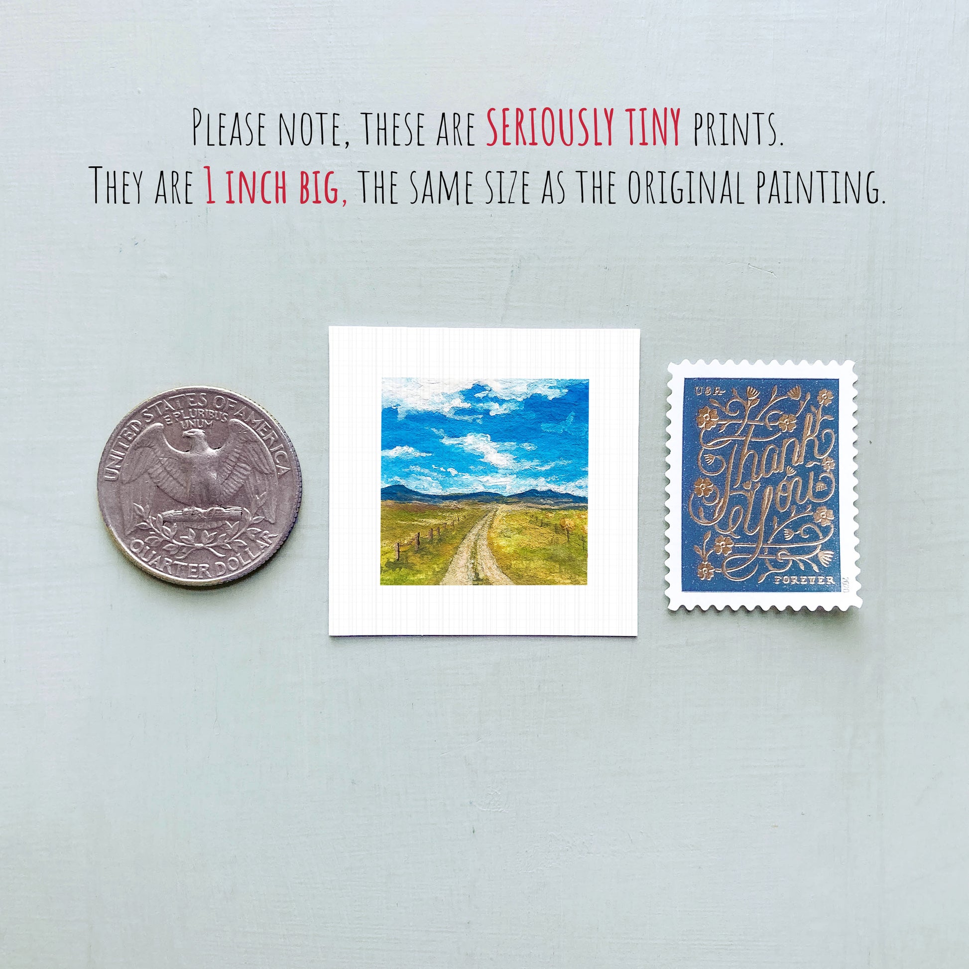 three small prints: a quarter, a postage stamp, and a painting of a rural landscape.