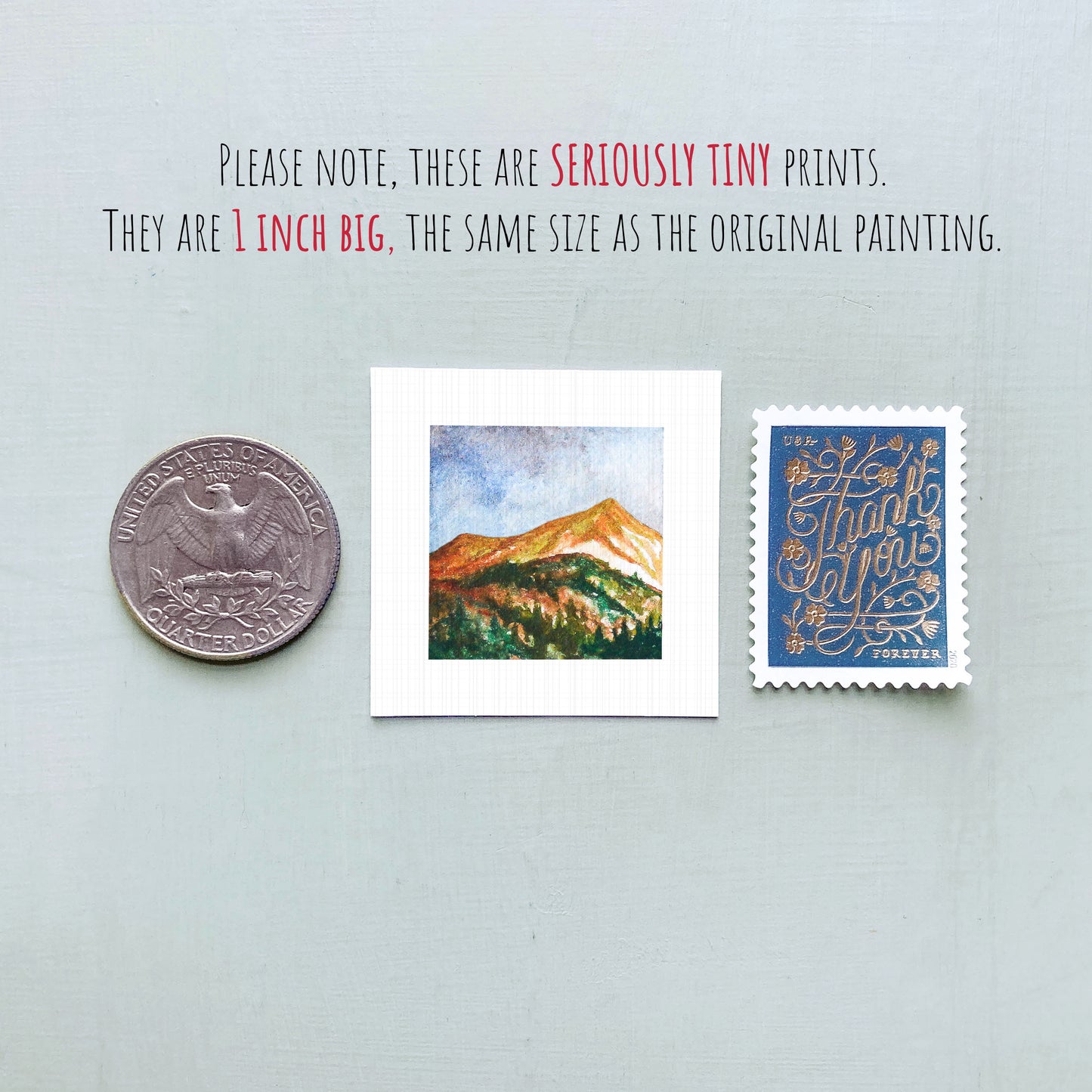 three small artworks: a coin, a square painting of a mountain landscape, and a postage stamp.