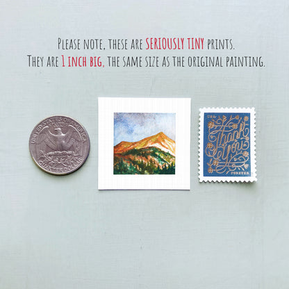 three small artworks: a coin, a square painting of a mountain landscape, and a postage stamp.