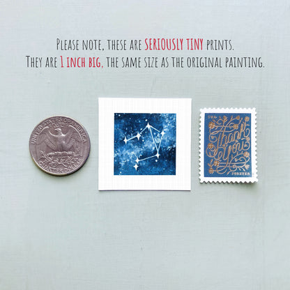 three small prints: a quarter, a square print with a blue background depicting a starry night sky, and a postage stamp.