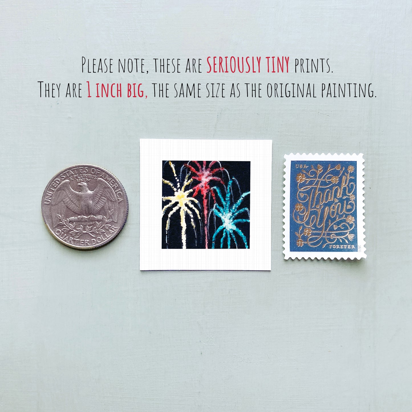 three small prints: a United States quarter, a square print with a fireworks display, and a blue postage stamp with gold lettering.