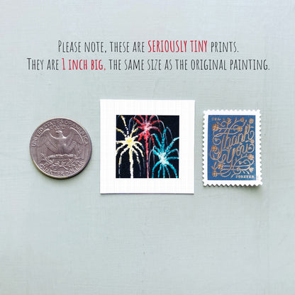 three small prints: a United States quarter, a square print with a fireworks display, and a blue postage stamp with gold lettering.