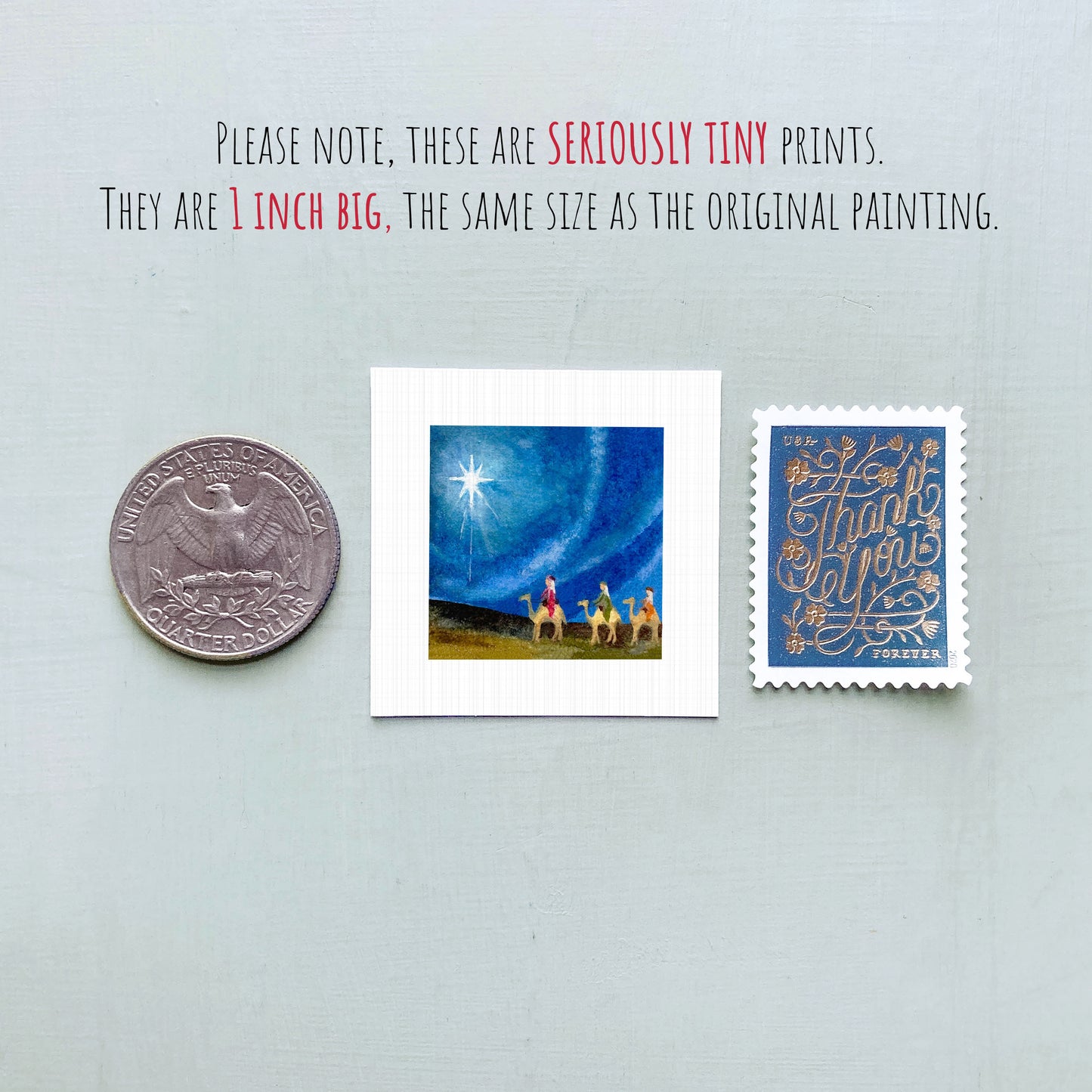 three small artworks: a silver coin, a small square print, and a blue postage stamp.