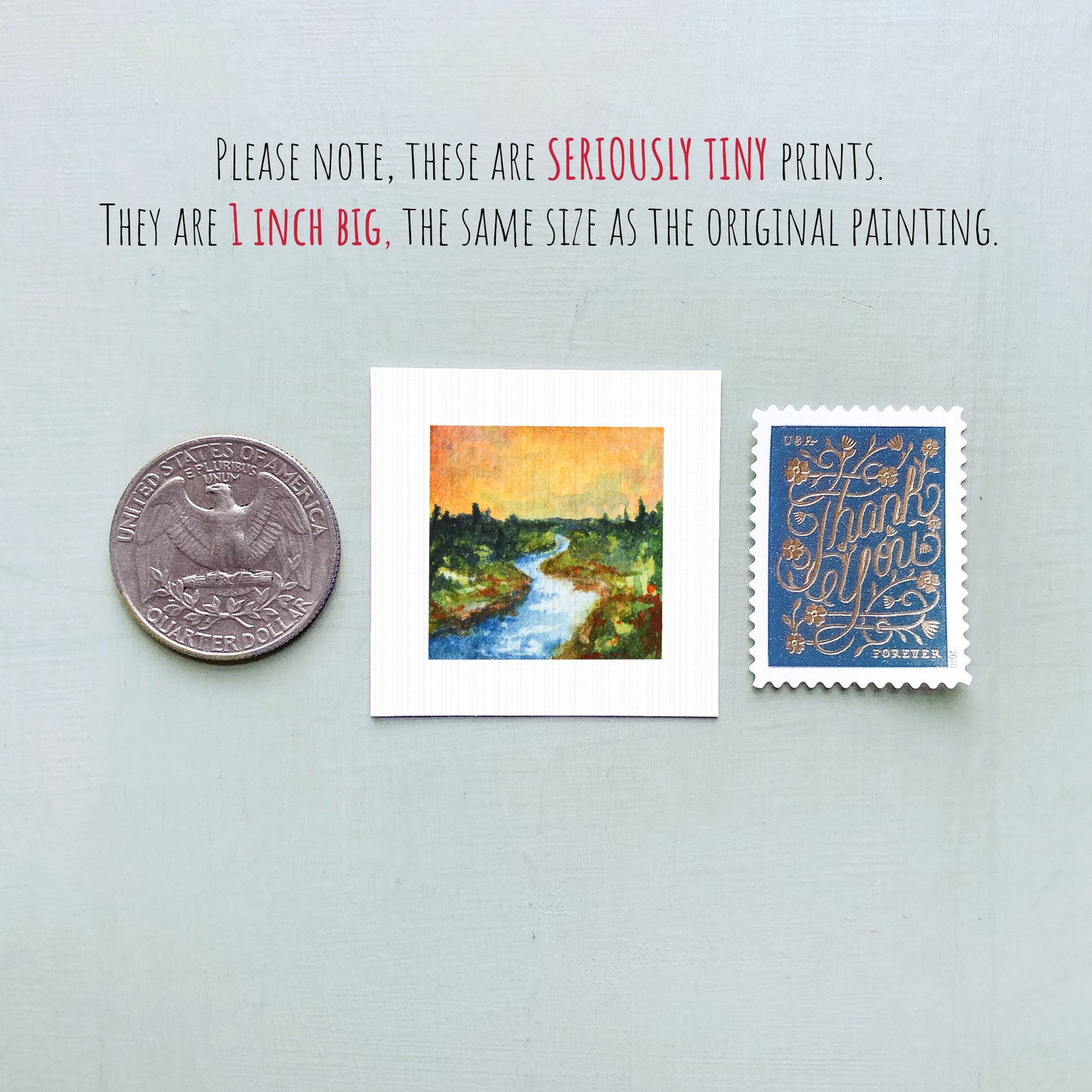 three small artworks or prints, including a coin, a painting of a river, and a postage stamp, all of which are described as "seriously tiny prints" and "the same size as the original painting".