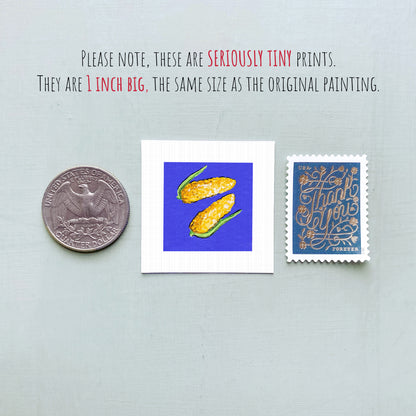 three small prints: a quarter, a square print with a blue background and yellow corn, and a postage stamp.